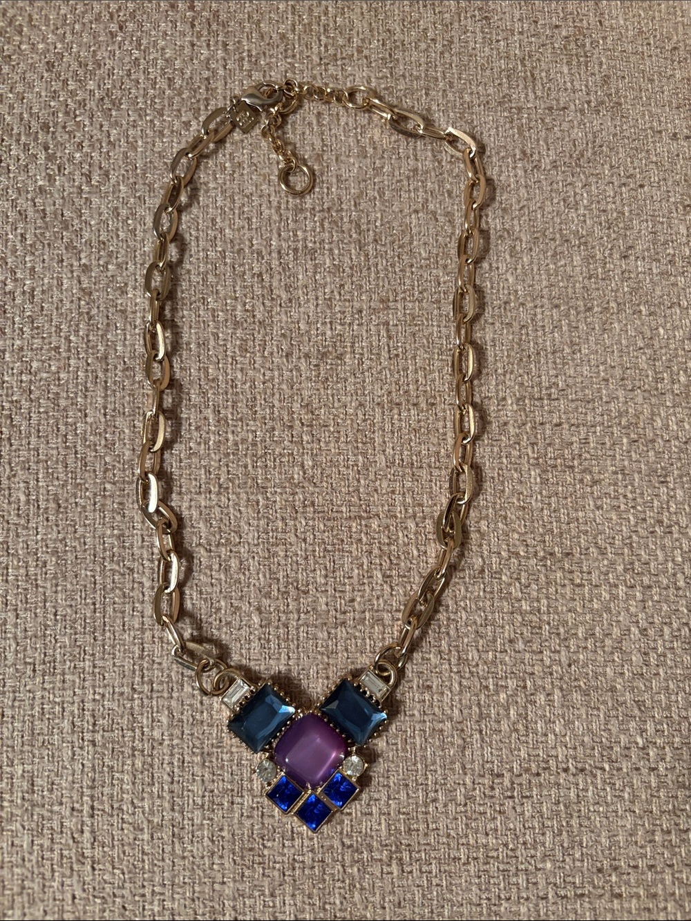 Necklace with Purple and Blue Gemstone Pendant on a  gold chain.